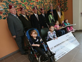 Shriners George Minto, Randy McNevin, David Kerr, Moe Howles, Don Warner and Gerald McQuarrie (back left to right) present Nathan Begin, Laura V. Sanchez, McKayla Warden and Madison Walsh (front left to right) with a cheque at the John McGivney Children's Centre in Windsor on Wednesday, May 18, 2016.