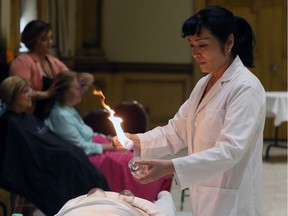 Acupuncturist Suzy S. Shuai demonstrates cupping therapy during DeStress For Distress, an event in support of Downtown Mission's Distress Centre Program on May 30, 2016.