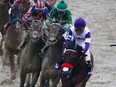 Nyquist, front, ridden by Mario Gutierrez and Exaggerator ridden by Kent Desormeaux lead the field in the fourth turn to win the 141st running of the Preakness Stakes at Pimlico Race Course on May 21, 2016 in Baltimore, Maryland.