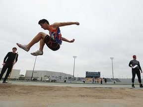 Evan John competes in the long jump during the WECSSAA Track and Field meet at Alumni Field at the University of Windsor in Windsor on Wednesday, May 11, 2016.