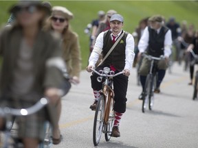 Participants in the 2016 Windsor Tweed Ride make their way along the Windsor riverfront dressed in old stylish attire, Saturday, May 7, 2016.