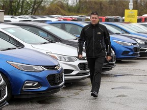 Retail sales manager Kris Cooper walks past a row of Chevrolet Cobalts at Reaume Chevrolet Buick GMC in Windsor on Tuesday, May 10, 2016. Chevrolet is rolling out incentives on many of its 2016 models.