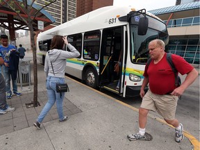 Passengers board a Transit Windsor bus at the downtown terminal on Thursday, May 12, 2016. Bus fares are going up across the board.