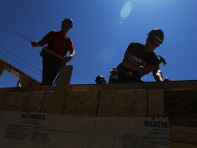 Volunteers work on a Habitat for Humanity build in Windsor on Thursday, May 19, 2016. Volunteers from FCA and St. Joseph's High School were on hand to assist with the framing.