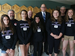 Mayor Drew Dilkens, fourth from right, meets Monday with members of the Holy Names Elementary School's robotics team at city hall: Emma Beaulieu, left, Mike Nadalin (coach), Judah McKinley, Mike Lamareau (coach), Samantha Wise, Mackenzie Cassidy, David Kostanjavec (coach) and Sarah Busch.