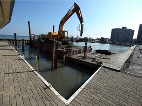 Construction crews work on the dock area of the Windsor Yacht Club in Windsor on Wednesday, November 11, 2015.