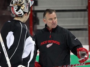 Detroit Red Wings coach Jim Bedard works with Windsor Spitfires goaltender Jordan DeKort during practice at WFCU Centre in this file photo.