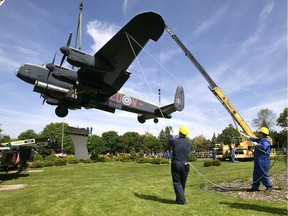 In this file photo, technicians guide the Lancaster Bomber off its pedestal in Jackson Park on May 26, 2005. The landmark aircraft, slated for restoration. was removed from its pedestal with the help of a massive crane.