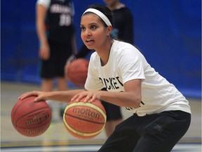 Miah-Marie Langlois, former guard with the CIS champion University of Windsor Lancers, demonstrates for about 45 basketball players during a skills camp at St. Denis Centre on Dec. 28, 2015.