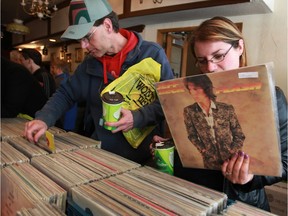 Marc Arrand, left, and his wife Jamie Little add to their vinyl collections at Villans Bistro on Pelissier Street Sunday May 15, 2016.