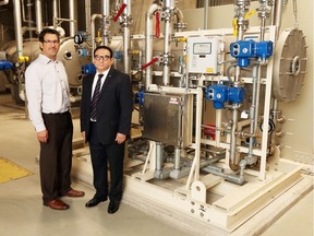Garry Rossi, director of water production, left,  and water treatment expert Dr. Saad Jasim talk about the ozone generator at the treatment plant in Windsor on May 19, 2016.