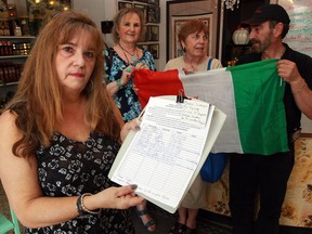 Valeri Cappussi, left, holds a petition to have a new honorary Italian vice-consul appointed as soon as possible May 25, 2016. The position was suppose to be filled in September 2014.