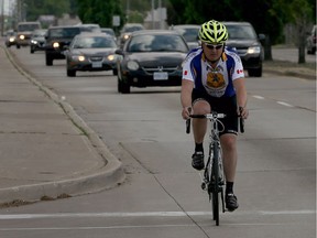 In this file photo, cyclist Sean Tomaselli bikes northbound on Walker Road on May 30, 2016.
