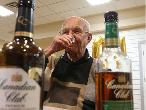 Don Gordon has a shot of Canadian Club Whisky at Chartwell Oak Park in LaSalle, Ont., on May 31, 2016.  The-101 year-old claims his health is due to the fact that he has had a shot of Canadian Club every day for over 80 years.