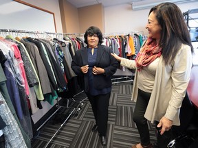 Rose Anguiano Hurst, right, executive director of Women's Enterprise Skills Training of Windsor helps client Maria Mendoza pick out a blazer on Monday, May 16, 2016.