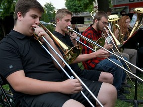 W. F. Secondary High School concert band musicians Charlie Harrison, left, Dylan Dugal and Matthew Oram perform on trombone during a free public concert at Reaume Park, Wednesday June 01, 2016.  Three levels of the impressive band performed, showing their appreciation of support throughout the school year.