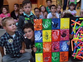 Holy Cross Elementary school kindergarten students display their pieces of art which were auctioned off for the family of former student Davis Foto, 10.  The Foto family lost everything one day after moving from LaSalle to Fort McMurray, Alta.