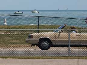 Motorists and pedestrians now have a clear view of Sand Point beach and Lake St. Clair.  Dark green fence inserts have been removed from the north side fence along Riverside Drive East.