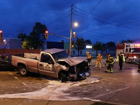 Firefighters clean up after a three car accident at the corner of Walker Road and Seneca Street in Windsor on Thursday, June 16, 2016. Several people were taken to hospital with non-life threatening injuries. A truck collided with two vehicles sending one in to the nearby Knights of Columbus smashing out a large window. (TYLER BROWNBRIDGE / WINDSOR STAR)