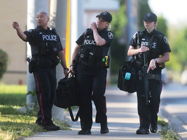 Windsor police officers are shown on Pillette Rd. on Wednesday, June 1, 2016 in Windsor, ON. Police set up a multi-block perimeter surrounding a residence on Pillette Rd. where a gunman was eventually arrested without incident. (DAN JANISSE/The Windsor Star)
