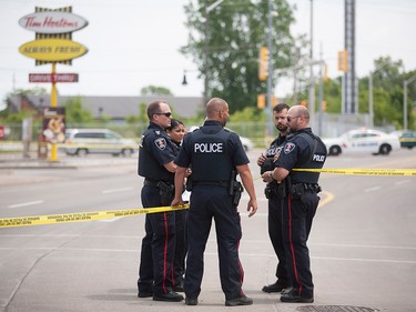 Windsor police officers investigate after a shooting outside the Tim Hortons at Wyandotte St. East and Walker Rd. after a shooting, Wednesday, June 22, 2016. The assailant is still at large. (DAX MELMER/The Windsor Star)