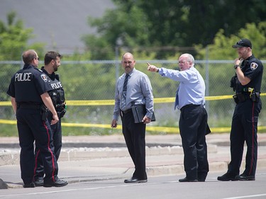 Windsor police detectives investigate outside the Tim Hortons at Wyandotte St. East and Walker Rd. after a shooting, Wednesday, June 22, 2016. The assailant is still at large. (DAX MELMER/The Windsor Star)