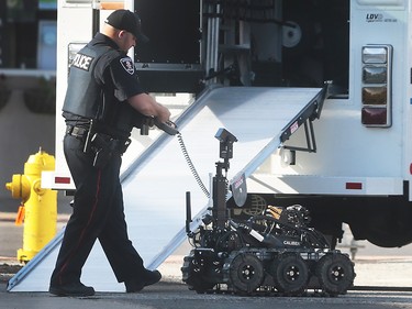 A Windsor police officer is shown with a tactical robot on Pillette Rd. on Wednesday, June 1, 2016 in Windsor, ON. Police set up a multi-block perimeter surrounding a residence on Pillette Rd. where a gunman was eventually arrested without incident. (DAN JANISSE/The Windsor Star)