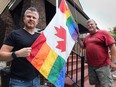 David Lenz (L) and Joe McParland are planning a vigil in response to the shootings at a gay nightclub in Orlando, FLA. They are shown with a Pride flag on Monday, June 13, 2016, in Windsor, ON. (DAN JANISSE/The Windsor Star)