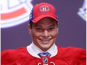 Windsor Spitfires defenceman Mikhail Sergachev celebrates with the Montreal Canadiens after being selected ninth overall during round one of the 2016 NHL Draft on June 24, 2016 in Buffalo, New York.