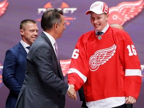 Dennis Cholowski celebrates with the Detroit Red Wings after being selected 20th overall during round one of the 2016 NHL Draft on June 24, 2016 in Buffalo, N.Y.