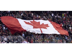 In this file photo, a giant Canadian flag was passed around the crowd during the national anthem prior to the game between the Ottawa Senators and Montreal Canadiens on "Hockey Day In Canada" at Scotiabank Place on Saturday, Jan. 30, 2010.