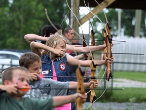 Jadelyn Lacroix, 10, centre, joins other children as they practice archery at the Windsor Sportsmen Club in this 2014 file photo.