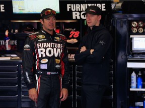 NASCAR driver Martin Truex Jr., left, talks with crew chief and London, Ont. native Cole Pearn in the garage area during practice for the Sprint Cup Series Axalta 'We Paint Winners' 400 at Pocono Raceway on June 6, 2015 in Long Pond, Penn.