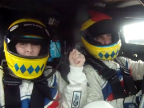 Portuguese race car driver Joao Barbosa, right, takes his wife Mariana for a ride in a two-seater version of his race car around Daytona International Speedway at speeds of 185 m.p.h.