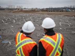 Minister of Infrastructure and Communities Amarjeet Sohi, right, and Michael Cautillo, CEO of the Windsor-Detroit Bridge Authority, tour the site for the future customs plaza to the Gordie Howe International Bridge on Dec. 17, 2015.