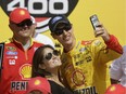 Joey Logano takes a photo with his wife Brittany Baca after winning the NASCAR Sprint Cup series auto race at Michigan International Speedway, Sunday, June 12, 2016 in Brooklyn, Mich.