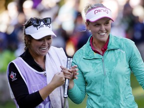 Brooke Henderson, of Canada, right, walks off the 18th green with her sister and caddy Brittany Henderson after winning the Women's PGA Championship golf tournament at Sahalee Country Club Sunday, June 12, 2016, in Sammamish, Wash.
