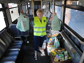 Shirley Hitchcock, from the Amherstburg Food and Fellowship mission displays some of the donations during the Stuff-a-Bus Food Drive event held at the Zhers store in LaSalle, ON on Friday, June 17, 2016.