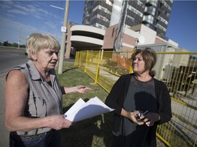Irisi Hotte, left, and Lisbeth Oksanen discuss the temporary cell phone tower located next to their apartment building, Thursday, June 23, 2016.
