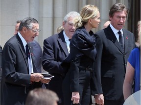 Walter Gretzky, left, father of Wayne Gretzky, right, and Janet Gretzky, centre, leave The Cathedral of the Most Blessed Sacrament on Woodward Avenue in Detroit following the funeral of Gordie Howe, Wednesday June 15, 2016.