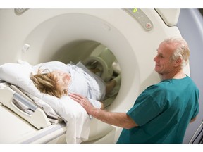 Doctor with patient during CT Scan. Photo by Getty Images.