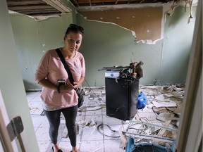 Cassandra Salidas checks out the damage to her Essex, Ont., home on June 13, 2016.
