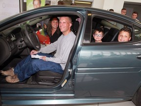 Shawn and Marta Galipeau and their children Colby and Collin test out their new wheels, a reconditioned 2006 Pontiac Grand Prix, during an unveiling ceremony at Dave Hitchcock Chevrolet in Essex on June 13, 2016.