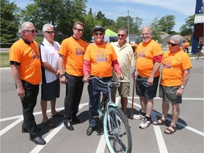 Frank Matthys, centre, is joined by Essex 73's past and present coaches and players, Keith Crowder, from left, Tony Piroski, Cam Crowder, Gil Langlois, Scott Miller, Dick Pluimers on June 2, 2016 at the Essex Sports Complex in Essex.