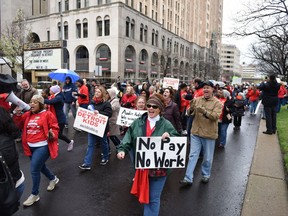 FILE - In this Monday, May 2, 2016, file photo, hundreds of teachers march during a rally in Detroit's New Center. Nearly all of Detroit's public schools were closed Monday, and more than 45,000 students missed classes after about half the district's teachers called out sick to protest the possibility that some of them will not get paid over the summer if the struggling district runs out of cash. Many urban school districts are watching with alarm as more students leave for charter schools. (Tanya Moutzalias/The Ann Arbor News-MLive Detroit via AP, File) LOCAL TELEVISION OUT; LOCAL INTERNET OUT; MANDATORY CREDIT ORG XMIT: MIARB901
