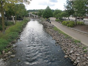 FILE - In this Sept. 12, 2013 file photo, the Fox River flows through downtown Waukesha, Wis. Representatives of the eight states in the Great Lakes region approved a Wisconsin city's request to tap Lake Michigan as its drinking water source, Tuesday, June 21, 2016 in Chicago. Waukesha says its groundwater is contaminated with radium. The city is only 17 miles from the lake. But because it lies just outside the Great Lakes watershed, it needed permission from all the region's states to use Lake Michigan water.