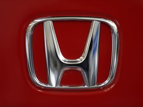 This Feb. 14, 2013, file photo, shows a Honda logo on the trunk of a Honda automobile at the Pittsburgh Auto Show, in Pittsburgh.