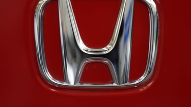 This Feb. 14, 2013, file photo, shows a Honda logo on the trunk of a Honda automobile at the Pittsburgh Auto Show, in Pittsburgh.