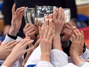 Finland players reach for the trophy as they celebrate their gold medal game win at the IIHF World Junior Championship in Helsinki, Finland on Tuesday, Jan 5, 2016.