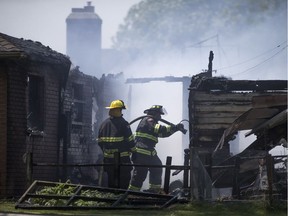 Leamington fire crews work to put out a fire that destroyed two homes on the 300 block of Robson Rd., Saturday, June 11, 2016.